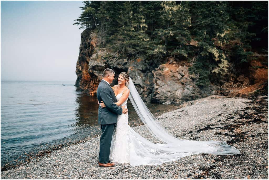 Coastal wedding venues in maine a man and woman in wedding dress on a beach.