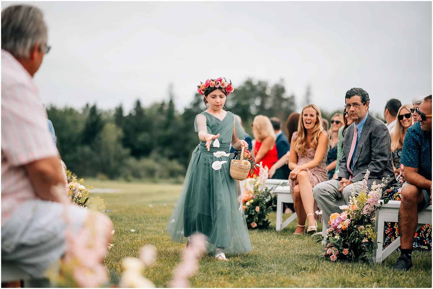 Flower girl walking down the aisle, scattering petals.
