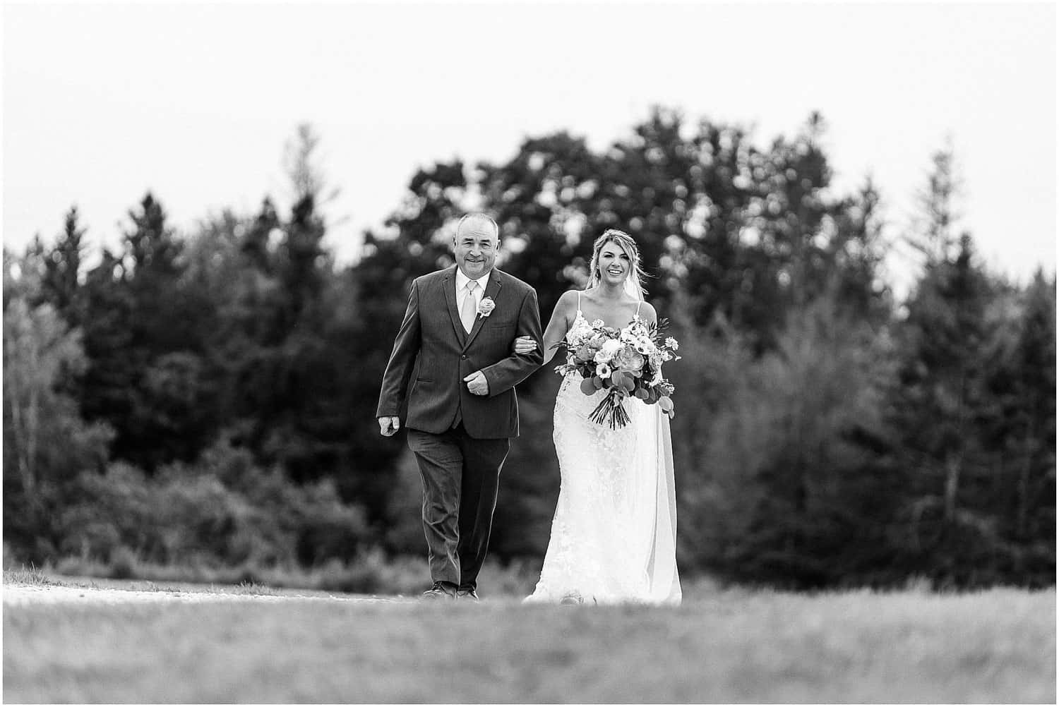 A bride walking with her father.