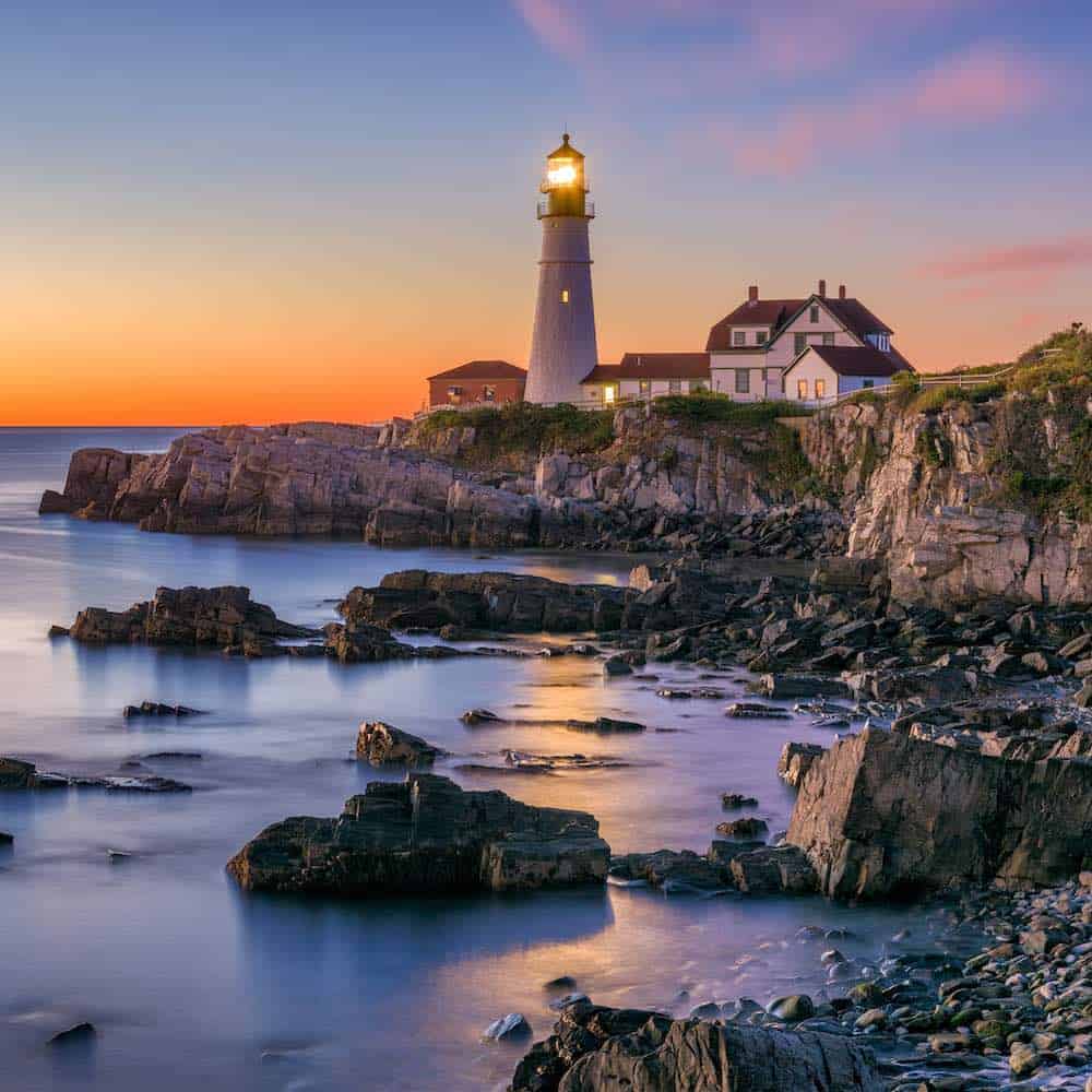Coastal wedding venues in maine portland head light sitting on a rocky shore.