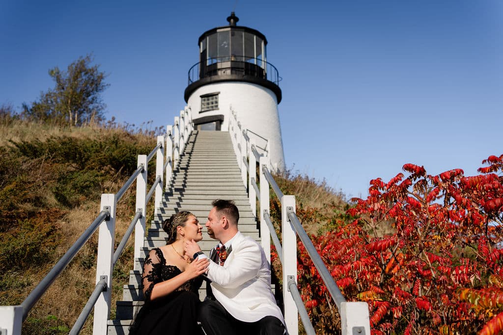 Best Maine Resorts For Weddings (Plus A Private Estate You Shouldn’t Miss) 1 Ash point estate maine resorts, newly weds pose and share a kiss on the stairs leading to a lighthouse