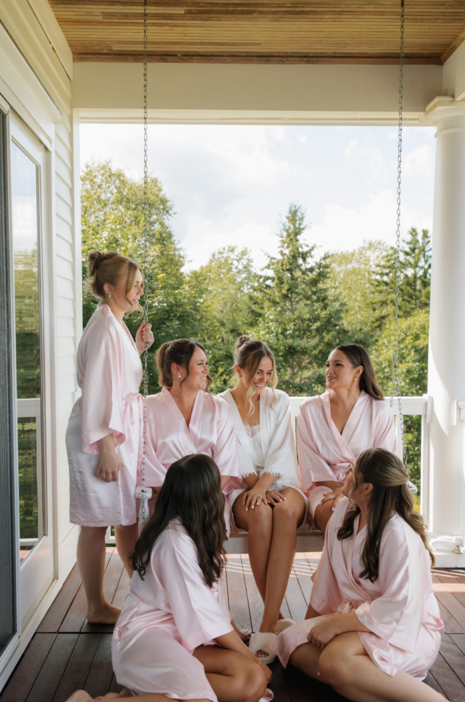 Ash point estate boothbay harbor, bridal party at ash point estate the morning of wedding. Bride is in white robe and bridesmaids are in pink robes.