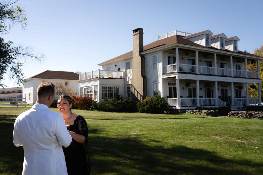 Destination Wedding In Maine, What Couples Need To Know Before Booking 5 Destination wedding maine, newlyweds hold hand and pose outside of ash point estate
