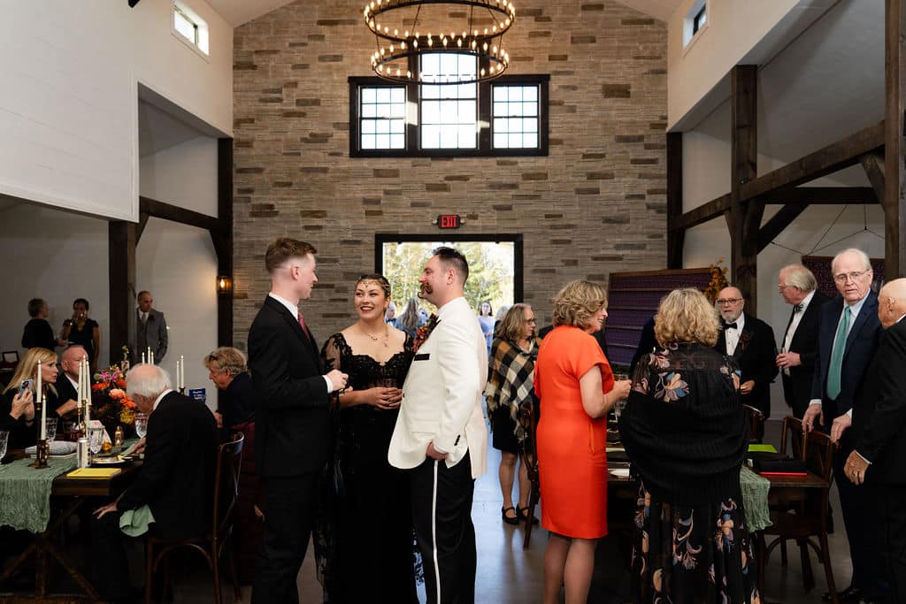 Family Resorts In Maine Vs. Private Coastal Estates: Which Is Right For Your Family Gathering? 4 Ash point estate an alternative to family resorts in maine, wedding guests stand inside and talk in reception area