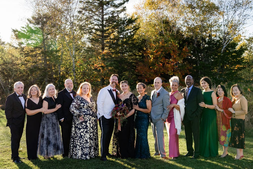 Family Resorts In Maine Vs. Private Coastal Estates: Which Is Right For Your Family Gathering? 3 Ash point estate an alternative to family resorts in maine, family joins bride and groom for photos on lawn