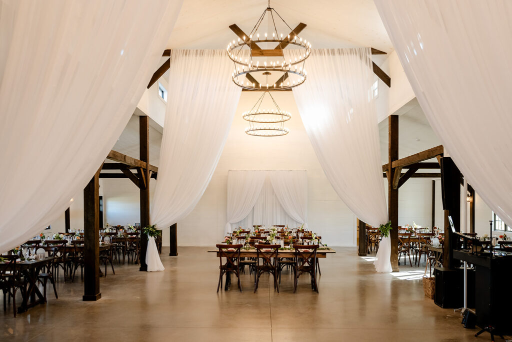 Ash point estate boothbay maine, view of reception space with flowy, white draping fabric