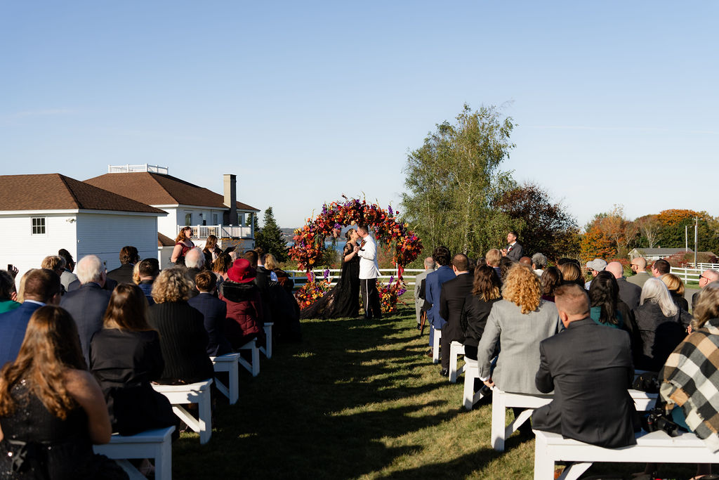Ash point estate wedding aisle with a floral arch altar at the end, places to have a wedding in maine